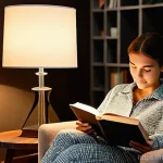 카페 분위기 나는 조명 - **Cozy Evening Reading Nook:** A young woman, fully clothed in comfortable, long-sleeved pajamas, is...